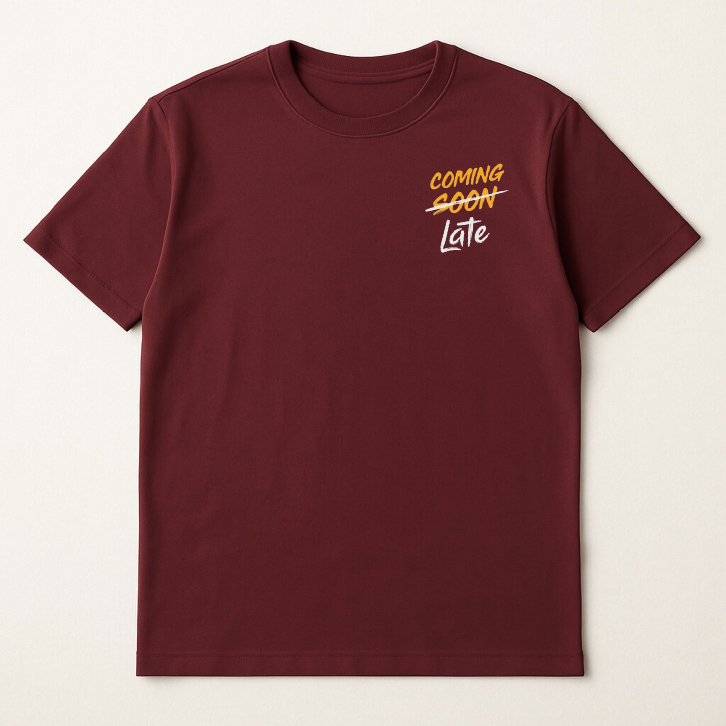 Maroon t-shirt with 'COMING SOON Late' text on a beige background