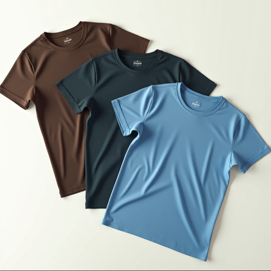Three t-shirts in brown, black, and blue on a light beige background
