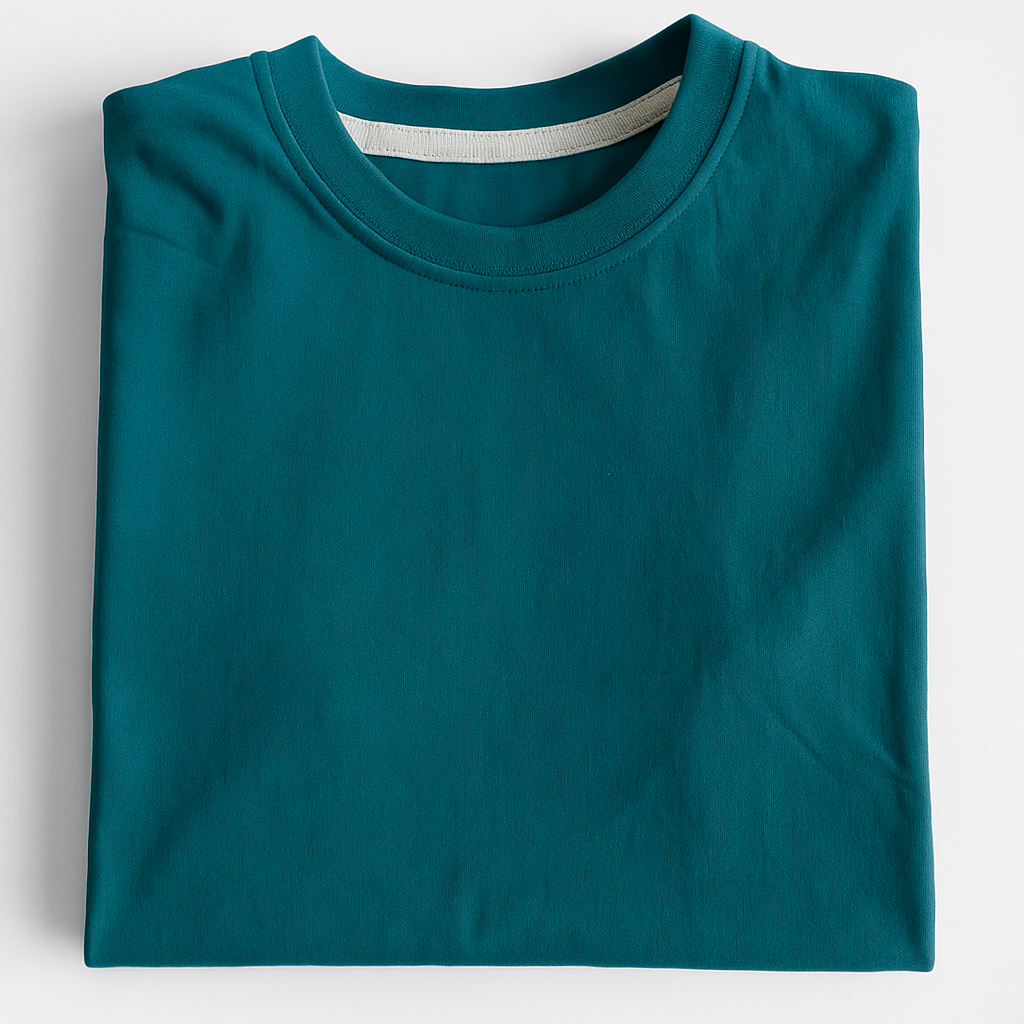 Folded teal t-shirt on a light gray background