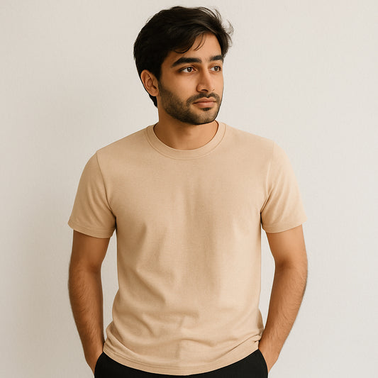 Man wearing a beige t-shirt against a plain background