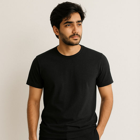 Man wearing a black t-shirt against a plain background