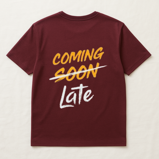 Maroon t-shirt with yellow and white text on a light beige background