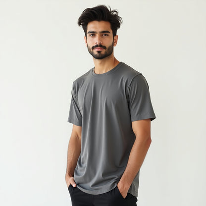 Man wearing a gray t-shirt against a plain background