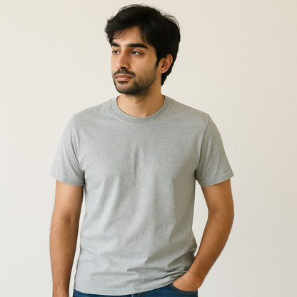 Man wearing a gray t-shirt against a plain background