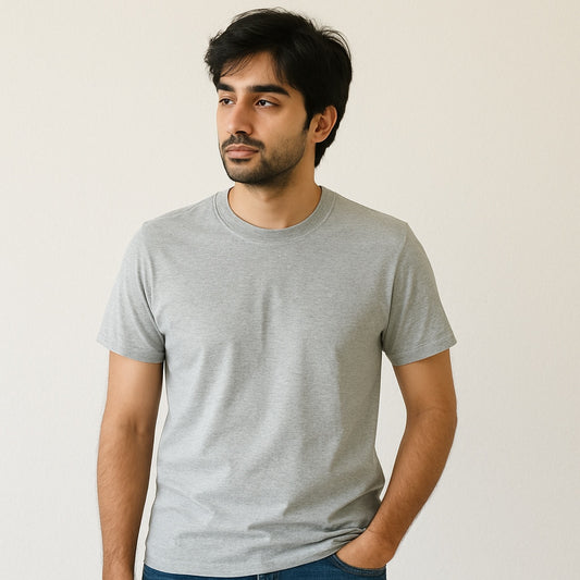 Man wearing a gray t-shirt against a plain background