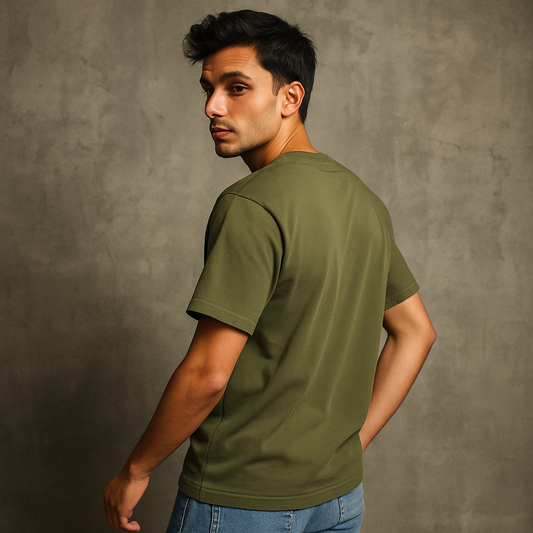 Man wearing an olive green t-shirt against a gray background