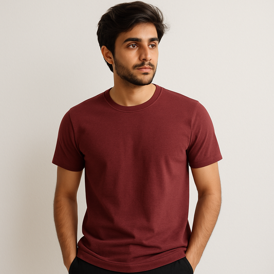 Man wearing a maroon t-shirt against a plain background