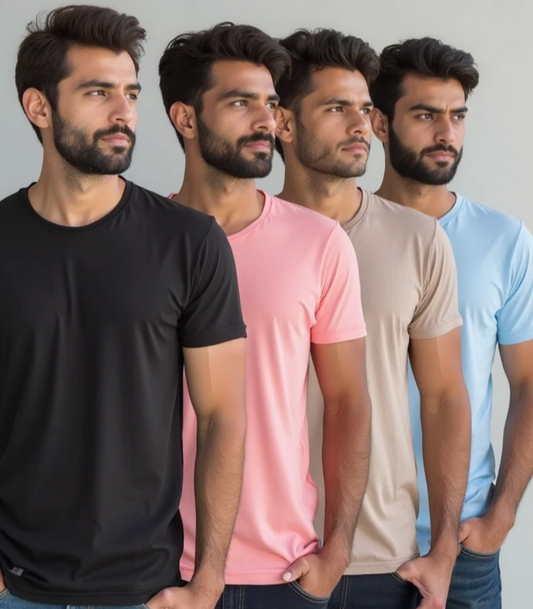 Four men wearing black, pink, beige, and blue t-shirts against a plain background