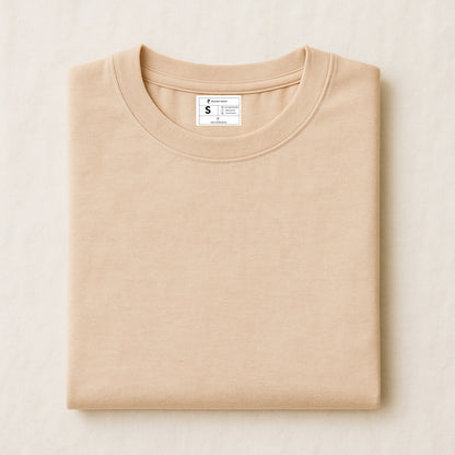 Folded beige sweatshirt with a label on a light beige background