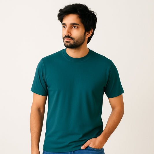 Man wearing a teal t-shirt against a plain background